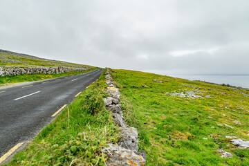 Spectacular misty landscape in the Burren region of County Clare, Ireland. Exposed karst limestone...