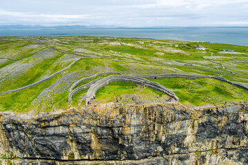 Dun Aonghasa or Dun Aengus, the largest prehistoric stone fort of the Aran Islands, popular tourist attraction, important archaeological site, Inishmore island, Ireland - obrazy, fototapety, plakaty
