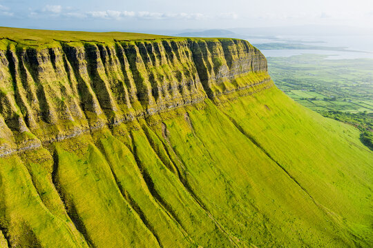 Aerial view of Benbulbin, aka Benbulben or Ben Bulben, iconic landmark, flat-topped nunatak rock formation. Magnificent costal driving route view at Wild Atlantic Way, County Sligo, Ireland.