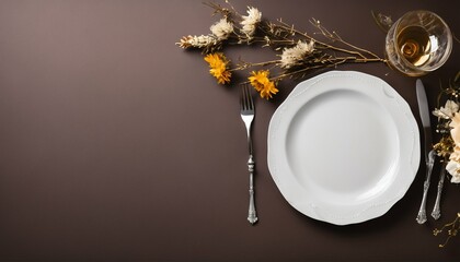 Elegant table setting, top view of empty plate, napkin, cutlery on brown, decorated with dry flowers