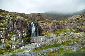 Small waterfall at the Conor Pass, one of the highest Irish mountain passes served by an asphalted road, located on the Dingle Peninsula, County Kerry, Ireland