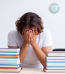 Young male student sitting in the classroom