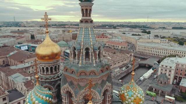 SAINT-PETERSBURG, RUSSIA - JUNE, 2023: Close-up aerial drone view of of the Church on Spilled Blood in Saint Petersburg. Beautiful domes and golden church cross on sunset.