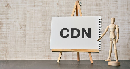 There is notebook with the word CDN. It is an abbreviation for Content Delivery Network as eye-catching image. - obrazy, fototapety, plakaty