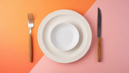 Empty wite plate on orange and pink pastel background. Top view with copy space