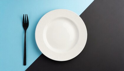 Empty wite plate on black and blue pastel background. Top view with copy space.
