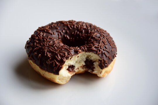 Ciambella, donut of yeast pastry with chocolate gassed on white background isolated and alone