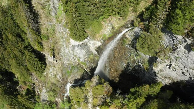 A waterfall around the lake of Saint Guerin in Europe, France, towards Beaufort, in the Alps, in summer, on a sunny day.
