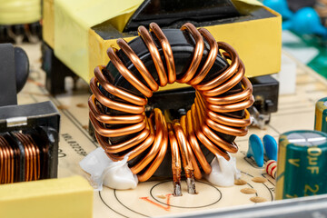 Inductor copper coil on circuit board of power supply - obrazy, fototapety, plakaty
