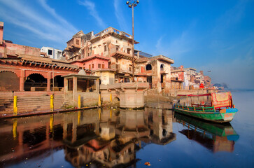 Mathura is a city in the Indian state of Uttar Pradesh. Photo is taken from the boat in Yamuna river - obrazy, fototapety, plakaty