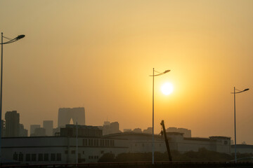 Golden sun during sunset and lamp post
