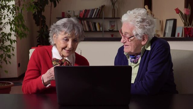 new technology: elderly couple use the computer at home