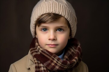 Portrait of a cute little girl in a warm hat and scarf. Winter fashion.