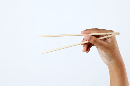 Hand Holding Bamboo Chopstick