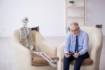 Old male psychologist meeting with skeleton