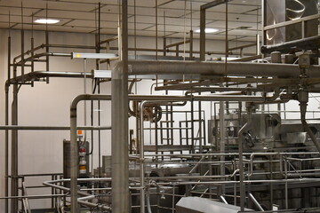 Stainless steel piping hanging from factory ceiling.