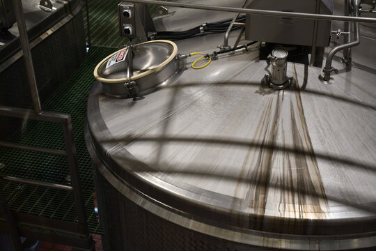 Top of stainless steel storage tank in factory.