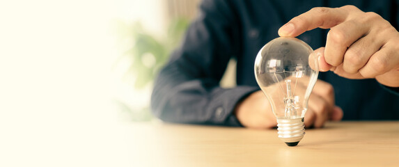 Hand choose light bulb not bright light for creative idea innovation of technology in analyzing...