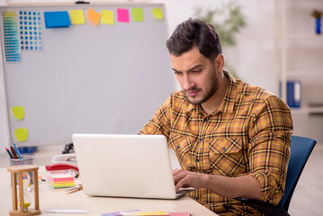 Young male designer working in the office