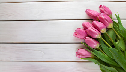bouquet of pink tulips on a white wooden background. top view. copy space. Holiday concept.