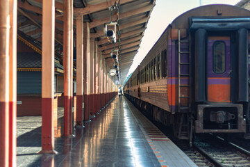A Single Person in the Distance Walking Alongside a Local Train on a Platform in Chiang Mai,...