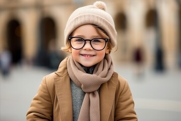 Outdoor portrait of cute little girl wearing warm clothes and eyeglasses