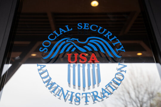 Redding, CA, USA - Mar 27, 2022: Closeup of the U.S. Social Security Administration (SSA) sign is seen on the door at its Redding office in California. Social Security is a social insurance program.