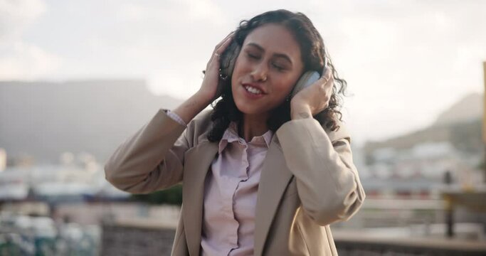 Happy, dance and woman in city with headphones, excited energy and streaming music in Cape Town. Lady, outdoor and girl with headset, listening to radio and relax with audio in morning with joy