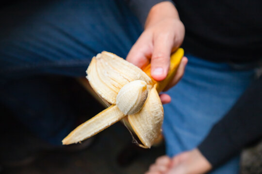 Male circumcision concept. surgical operation to dissect the frenum of the foreskin in men concept. circumcision of the foreskin, phimosis. Potency concept, impotence, male strength. Man holds banana