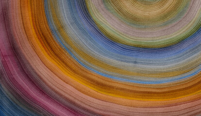 Deep colorful rainbow colors of tree rings background pattern with curved lines growing from center
