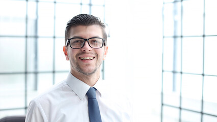 A male office worker looks at the camera in close-up