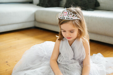 cute caucasian girl in gray tulle Princess Dress Enjoying Playful Moments