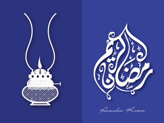 Paper Cut Vintage Oil lamp with Arabic Language Calligraphy of Ramadan Kareem on Blue Background.