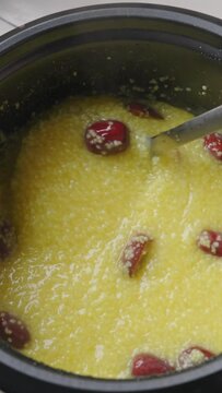 millet congee or millet porridge with jujube in pot	

