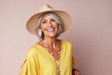 Portrait of a beautiful mature woman in hat and yellow blouse