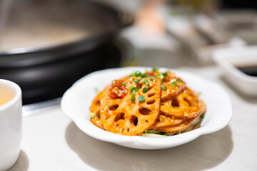 A plate of cold lotus root on the restaurant table