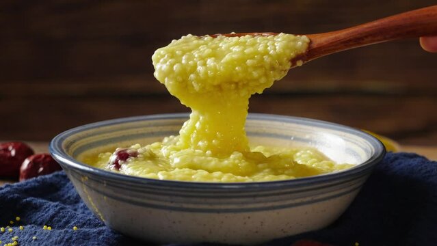 millet congee or millet porridge with jujube in a bowl on tabe.