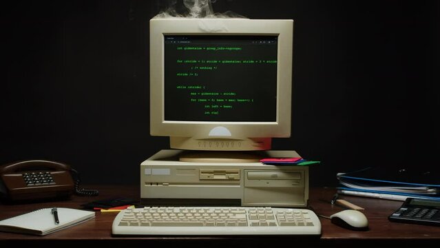 Retro pc with smoke on monitor with loading code console, programmer making scripts, green basic screen, Old computer studio close-up, Desktop vintage retro wave display, late 90s PC.