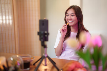 Young asian vj women use digital smartphone and recording video to speaking morning talks about...