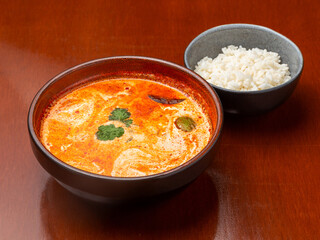Tom yum soup with rice in a plate.