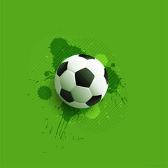 realistic soccer ball on green background with splatter effect