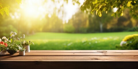 Wooden table displaying products with a lush spring garden backdrop of green grass, leaves, and sunlight. - obrazy, fototapety, plakaty