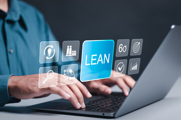 Lean manufacturing and six sigma management. Person use laptop with lean word on virtual screen for quality standard in industry, continuous improvement,  improve productivity and efficiency.