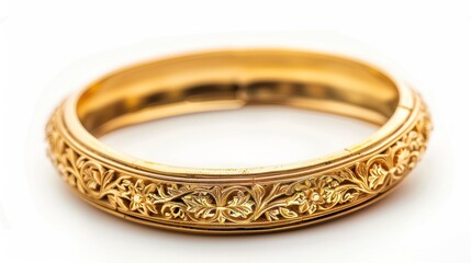 Big gold bangle bracelet with beautiful pattern isolated on white background.