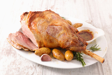 baked lamb leg, sauce and potatoes © M.studio