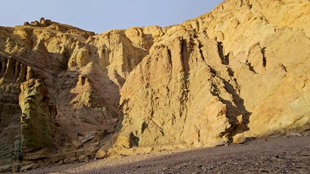 Pan-low sun lights the walls of Golden Canyon in Death Valley.  The hike through Golden Canyon is a popular attraction in Death Valley National Park.