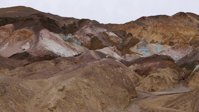 Pan-Multi colored hills of Artist Palette. Iron-rich hematite gives reds and pinks, iron oxides yield yellows and golds, volcanic ash deposits give greens and manganese creates purple - Death Valley