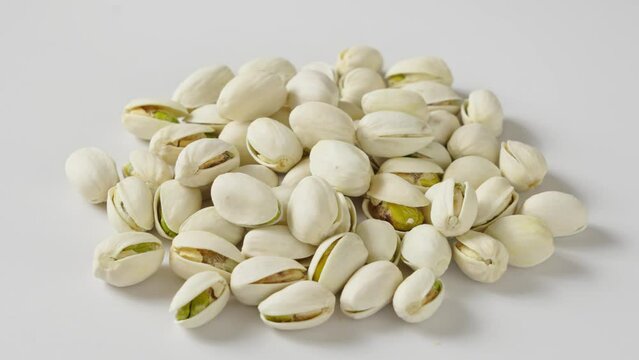 roasted salted pistachio nuts on white background.