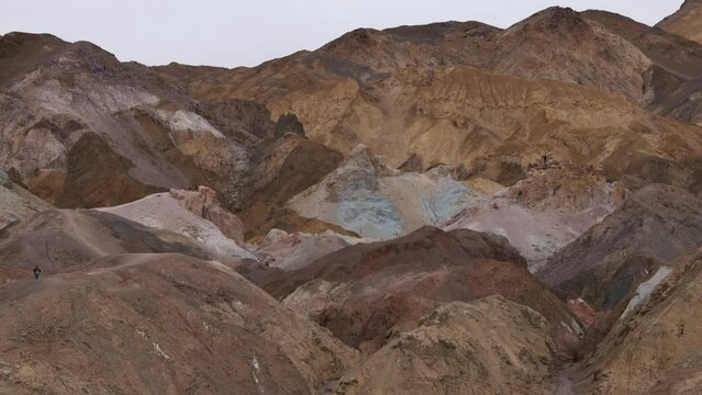 Pan-Multi colored hills of Artist Palette. Iron-rich hematite gives reds and pinks, iron oxides yield yellows and golds, volcanic ash deposits give greens and manganese creates purple - Death Valley