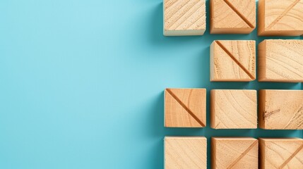 Wooden blocks with an arrow at the bottom, featuring minimalist grids in sky-blue hues, embodying minimalist precision, socially engaged work, and the use of common materials.